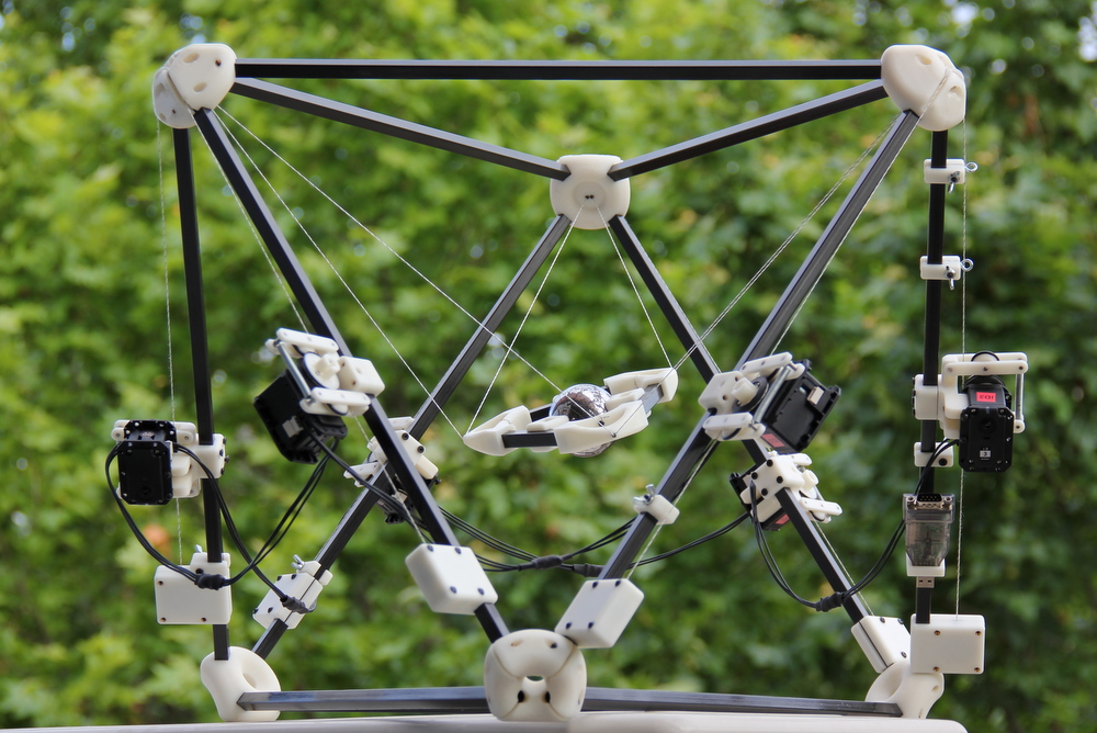 This
                image shows the Hexacrane, a cable-driven hexapod
                constructed by the Kinematics and Robot design group at
                IRI